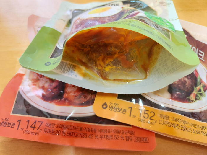 함박스테이크 포장 하단 부분을 양쪽으로 당겨 벌린 상태