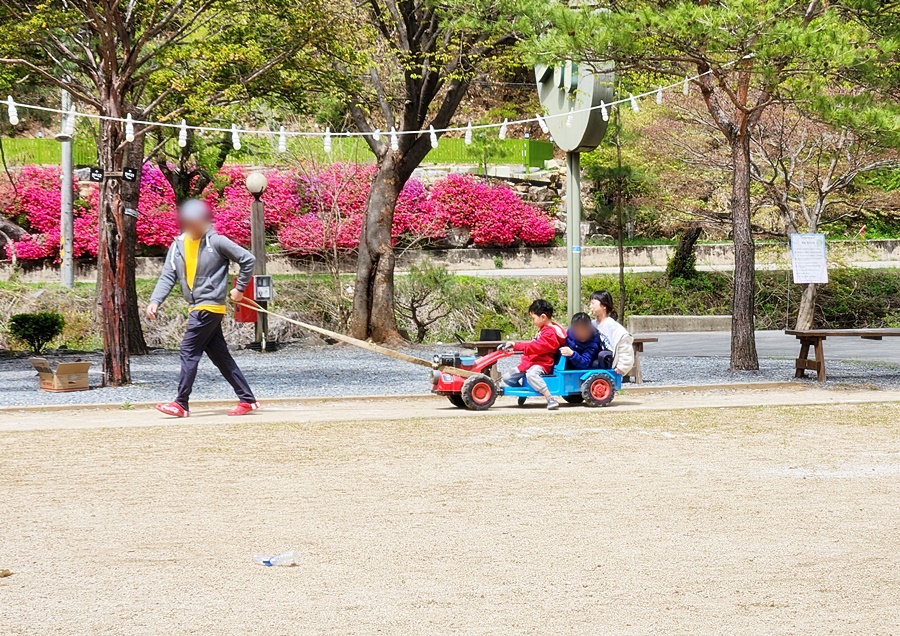 길따라 장난감 자동차를 타는 아이들