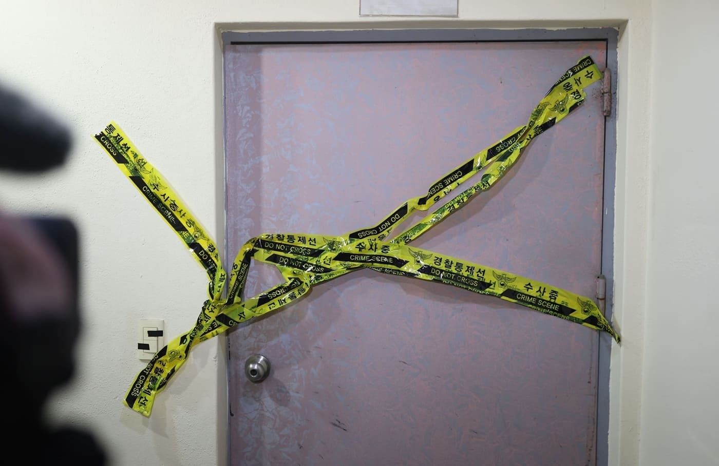 Police tape has been set up on the stairs of a motel in Changwon City.