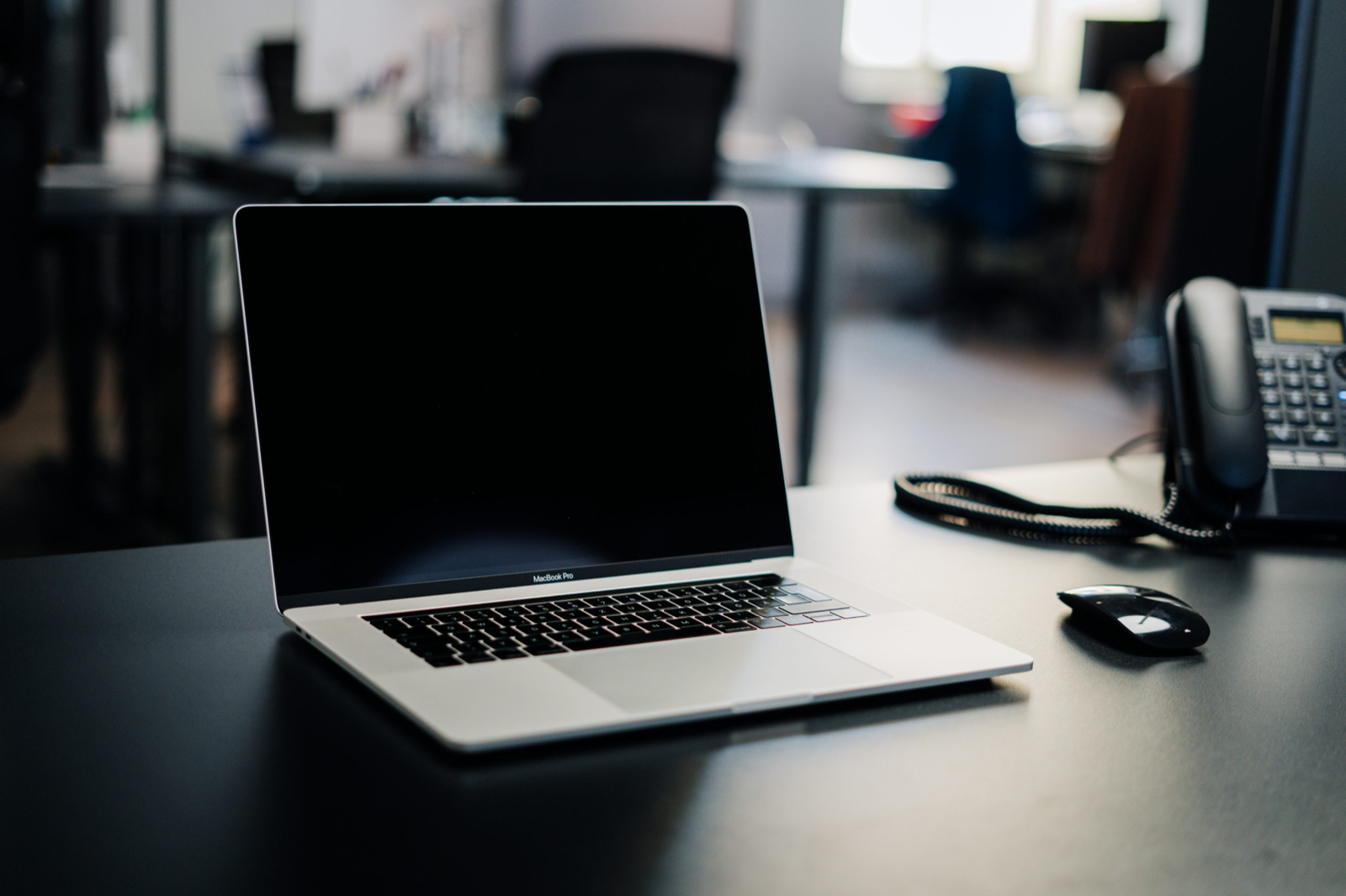 책상 위 MacBook Pro와 마우스가 놓인 작업 공간을 보여 주는 Unsplash 자료사진