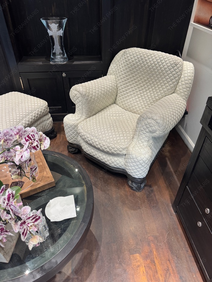 A luxury Chrome Hearts quilted white leather armchair and a crystal cross vase inside the Paris flagship store private lounge