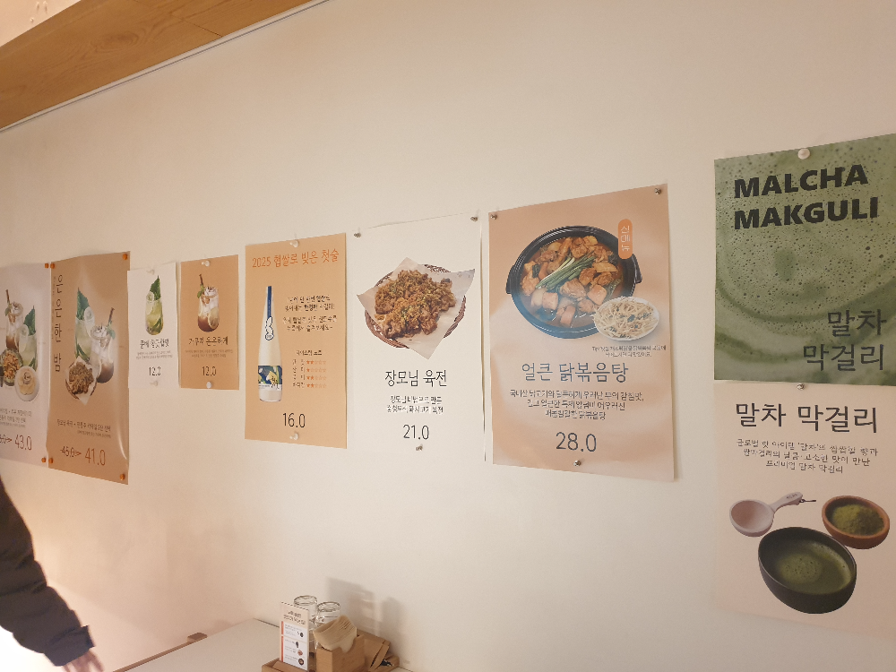 흰 벽에 부착되어 있는 다양한 메뉴 POP 들