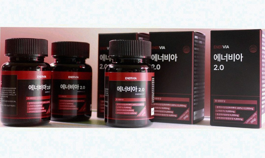 Korean Asian man 42 checking multiple supplement bottles on table morning light