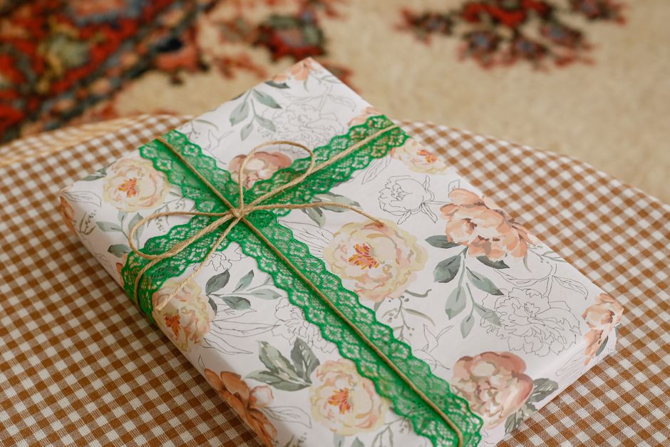 Beautiful floral gift box with green ribbon, perfect for birthdays or special occasions.