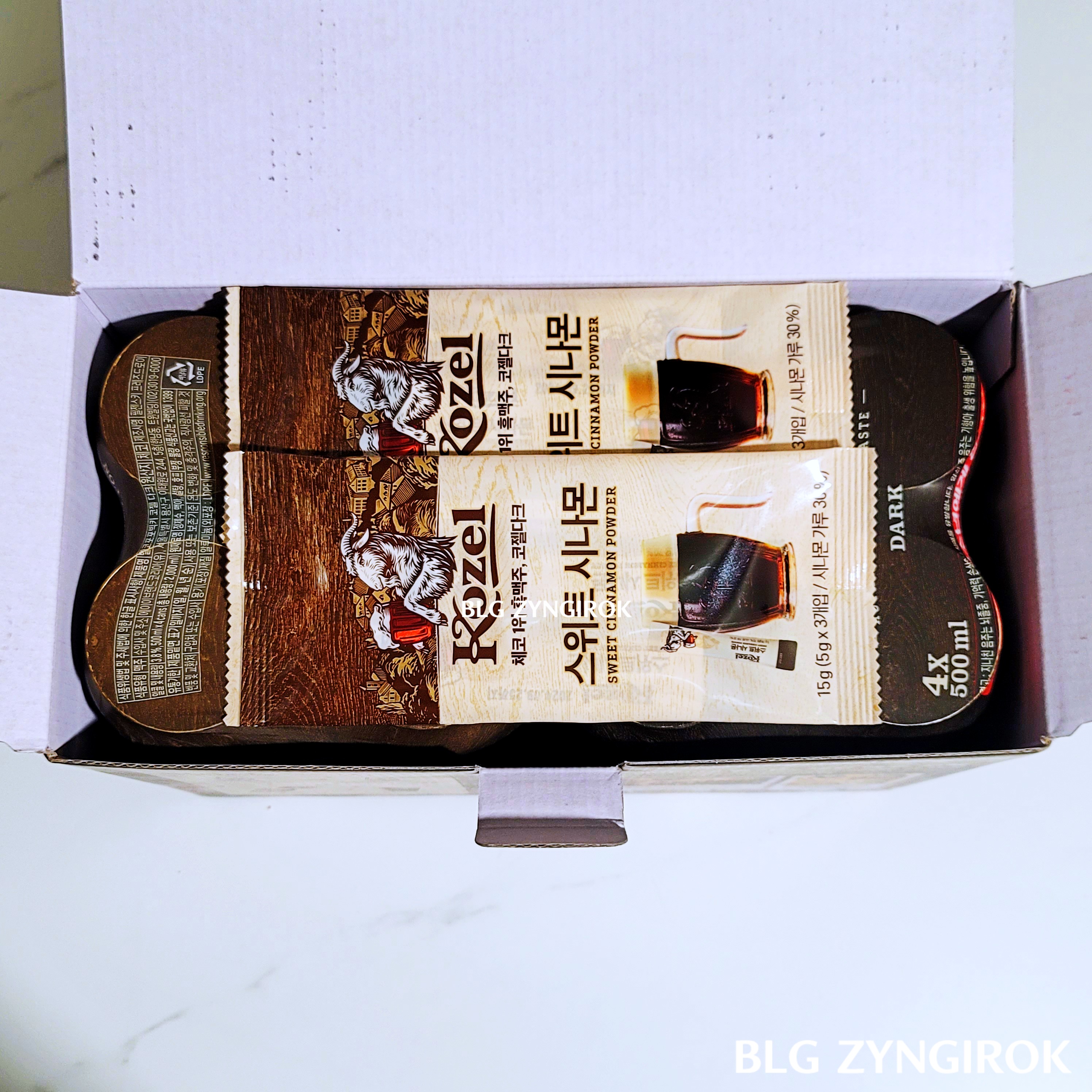 코젤-다크-상자를-연-모습이다.-맥주위에-봉지-두개가-놓여있다.