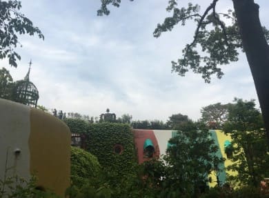 나무들이 우거져 있는 장소 멀리 로봇의 형상의 보인다