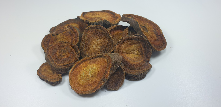 야생에서 채취를 한 대황풀의 뿌리를 깨끗하게 세척을 한 후에 건조시킨 것을 편으로 크게 썰어놓은 것을 하얀 바닥 위에 수북하게 놓아두고 찍은 사진