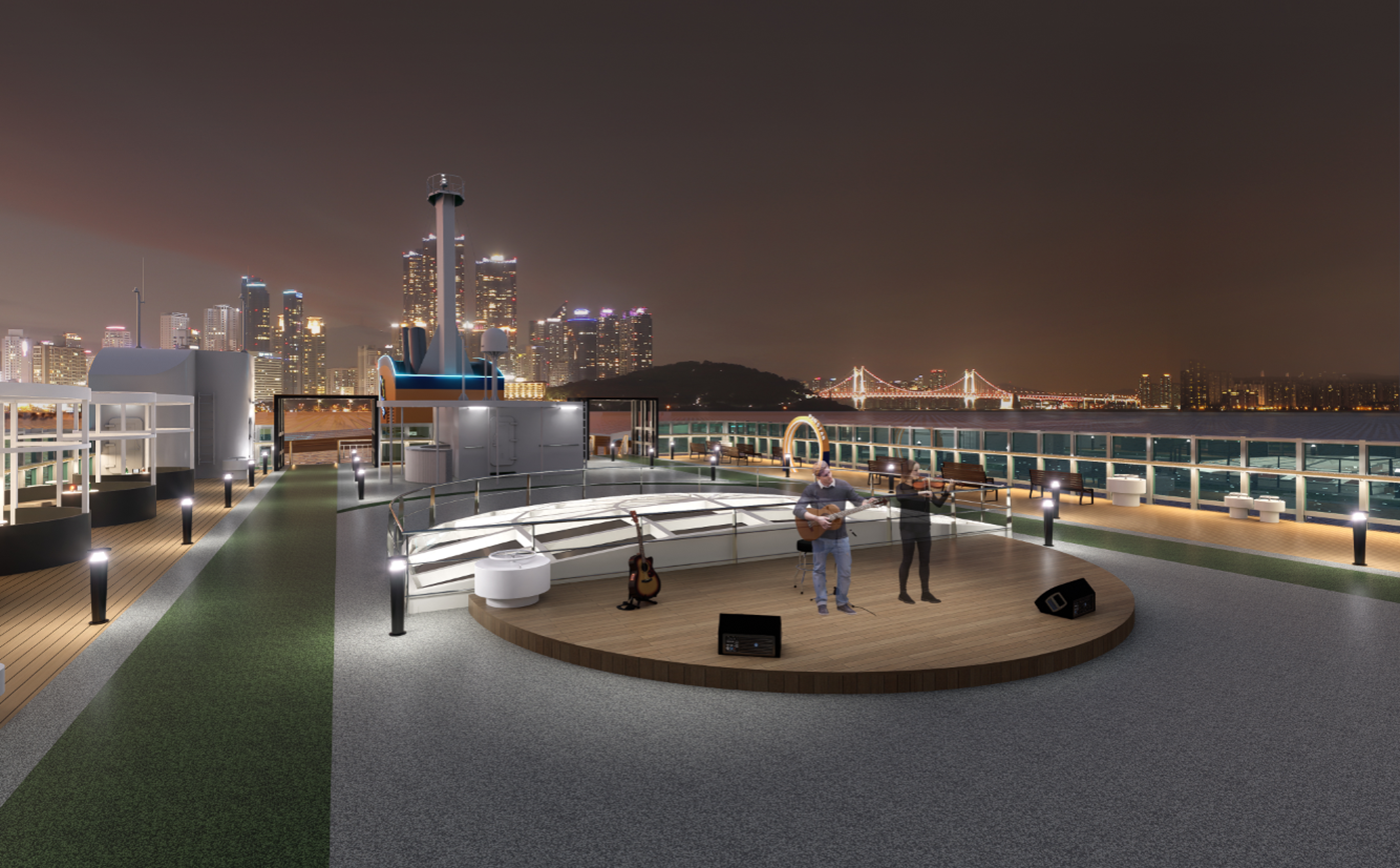 &ldquo;팬스타미라클호의 하늘정원 야외 무대 전경. 둥근 원형 무대 위에서 연주자들이 기타와 바이올린 공연을 펼치고 있으며&amp;#44; 주변에는 도시의 야경과 광안대교가 배경으로 펼쳐진다. 무대 주변에는 조명이 설치되어 있으며 산책로와 벤치가 조성된 야외 휴식 공간이다.&rdquo;