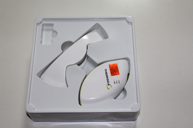 In-box tray showing the thermometer and stand with orange backlight on.