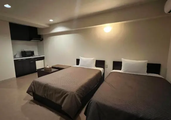 Condominium-style hotel room at Hotel Monpa with two beds in Okinawa