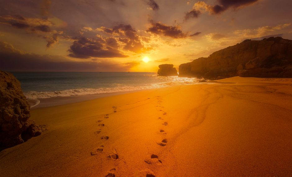 Experience tranquility with this breathtaking beach sunset, featuring golden skies and sandy shores.