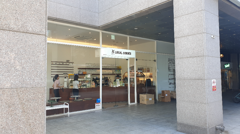 큰 기둥 안쪽에 흰색 프레임에 대형유리로 된 카페