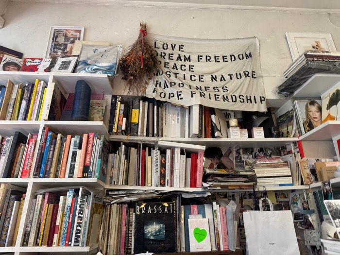 Floor to ceiling bookshelves crowded with art books and indie magazines inside Ofr Paris ❘ Librairie Ofr⁠