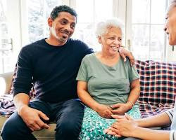 치매 환자와 가족이 소파에 앉아 다정하게 대화하는 모습