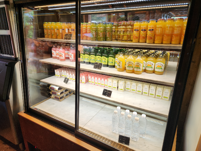 There are fruit juices, milk, and water in the refrigerator.