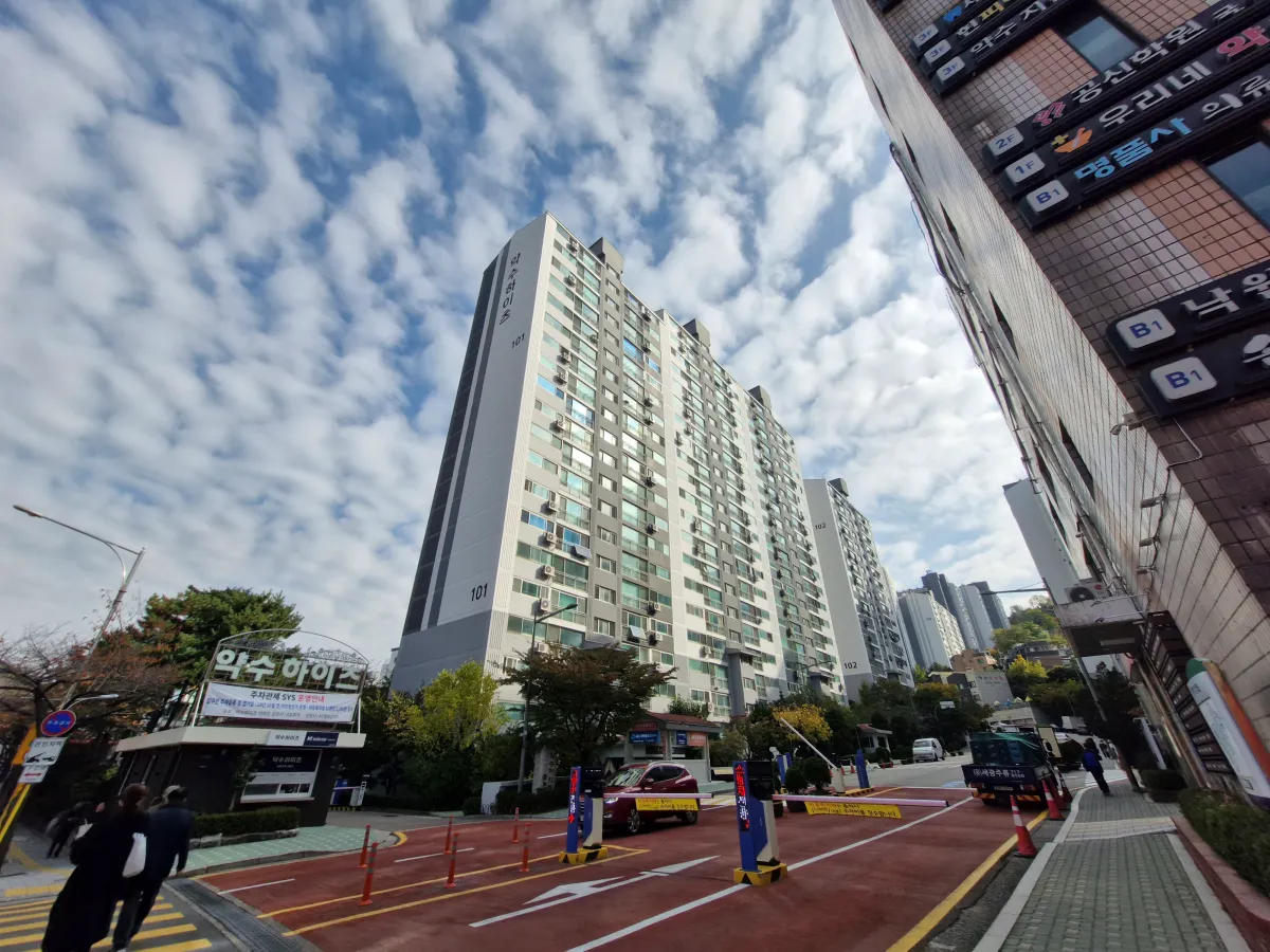 푸른하늘아래-아파트-앞으로-사람들이-지나다니고-있다