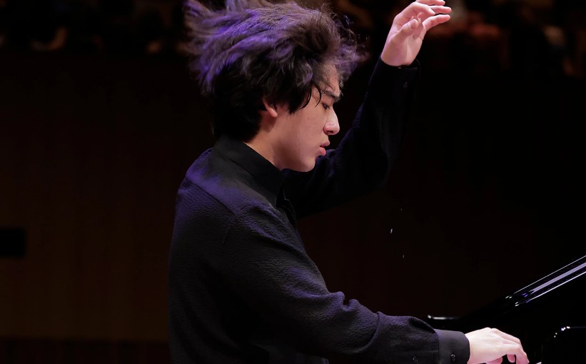 Yunchan Lim playing the piano with hair flying