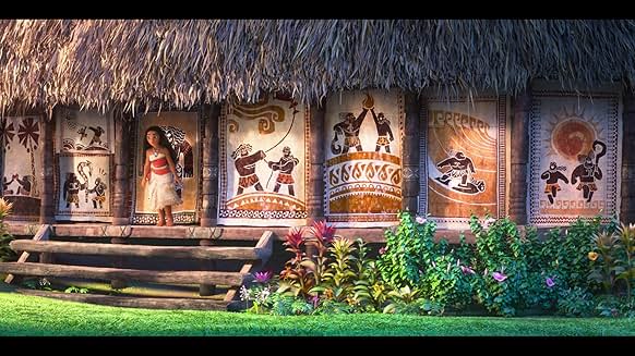Moana walking past Polynesian murals on a village wall in Moana 2