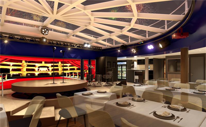 “팬스타미라클호 내 공연형 레스토랑 내부 전경. 중앙에 원형 무대와 마이크가 설치되어 있으며, 배경에는 빨간 커튼과 좌석 형태의 무대 연출이 되어 있다. 천장은 유리 돔 구조로 설계되어 불꽃놀이가 보이는 밤하늘이 연출되며, 테이블마다 식기가 세팅된 고급 다이닝 공간이다.”