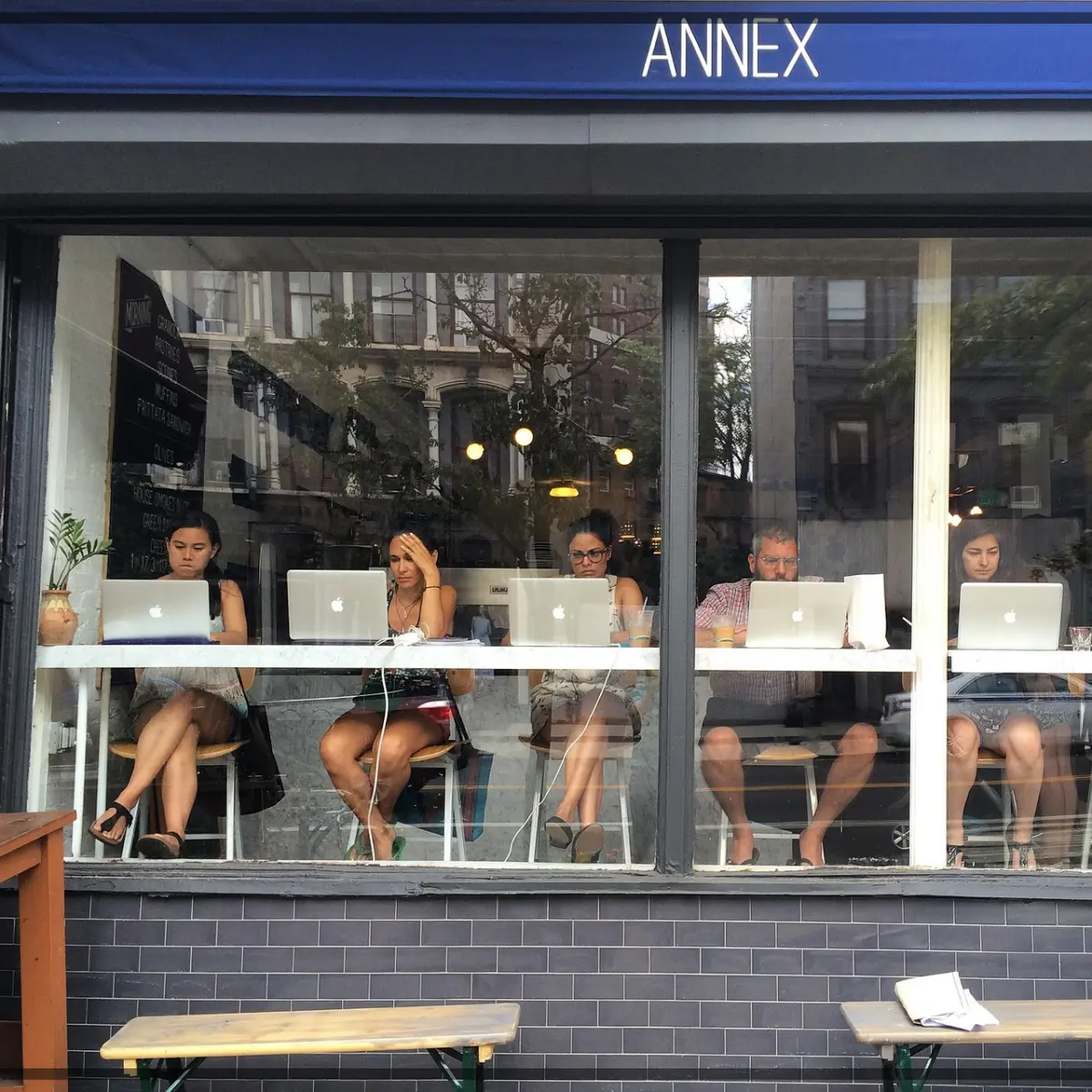 people doing computer work at the coffee shop