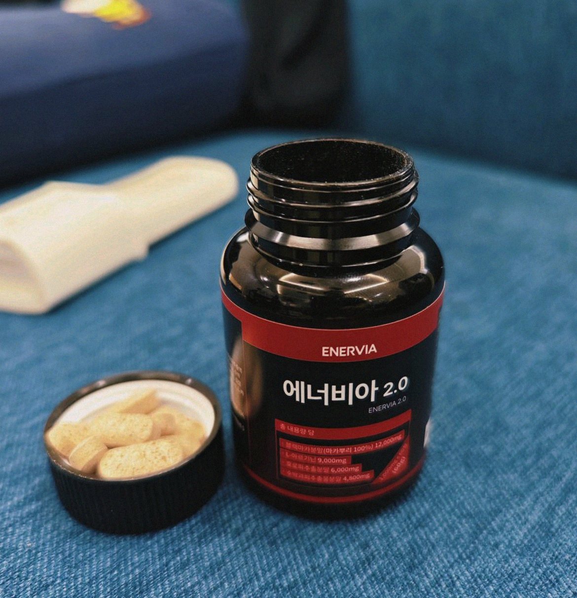 Korean Asian man taking supplement after workout at home