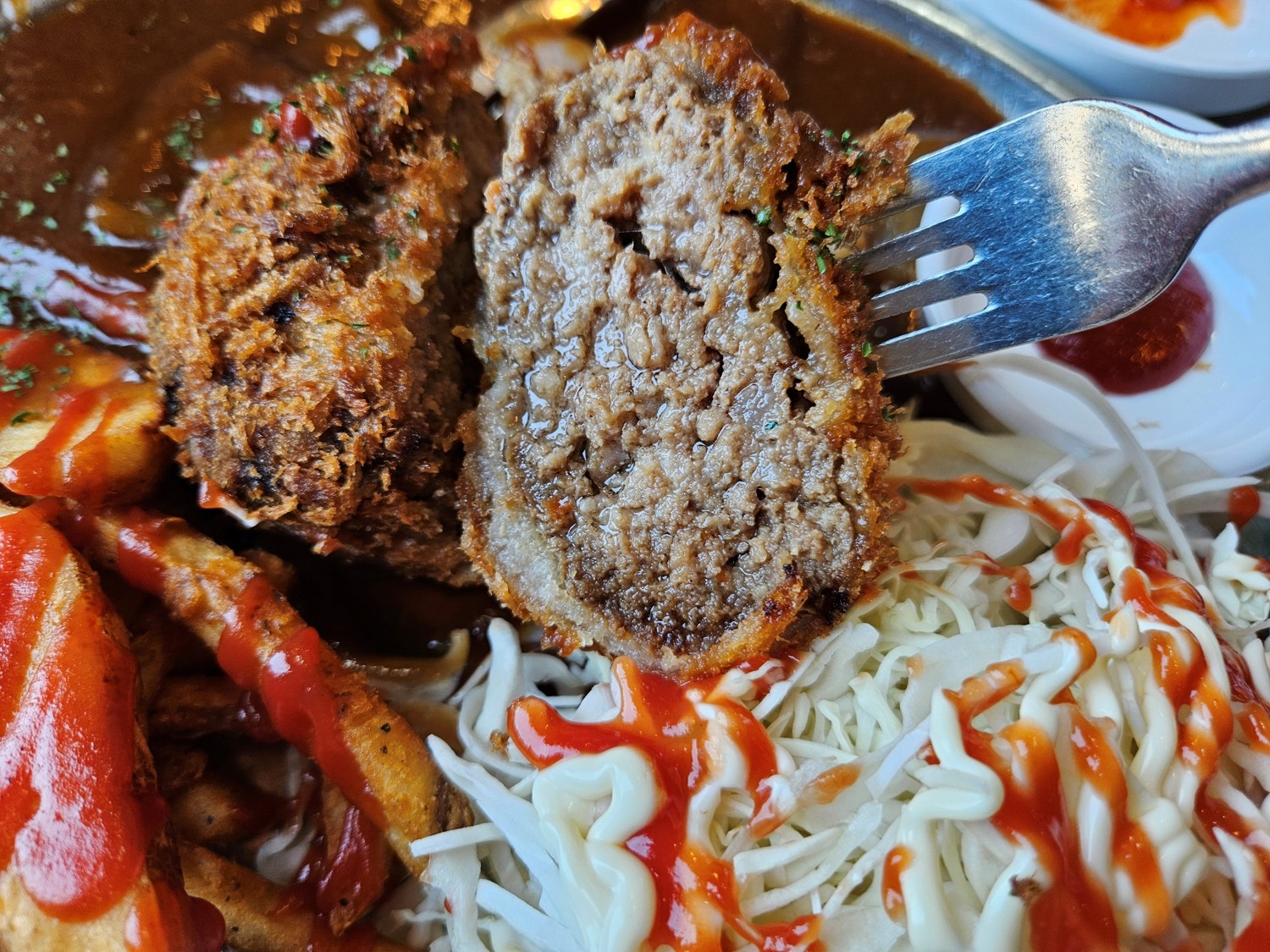 부산 9대맛집 고관함박에서 파는 고관까스를 반으로 잘라 포크로 찍어 든 모습
