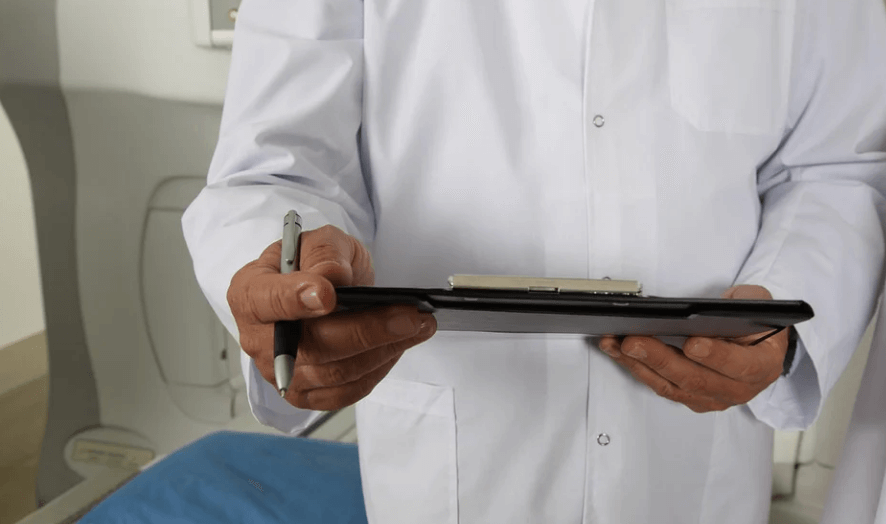 의사가 차트를 보고 고민중에 있다