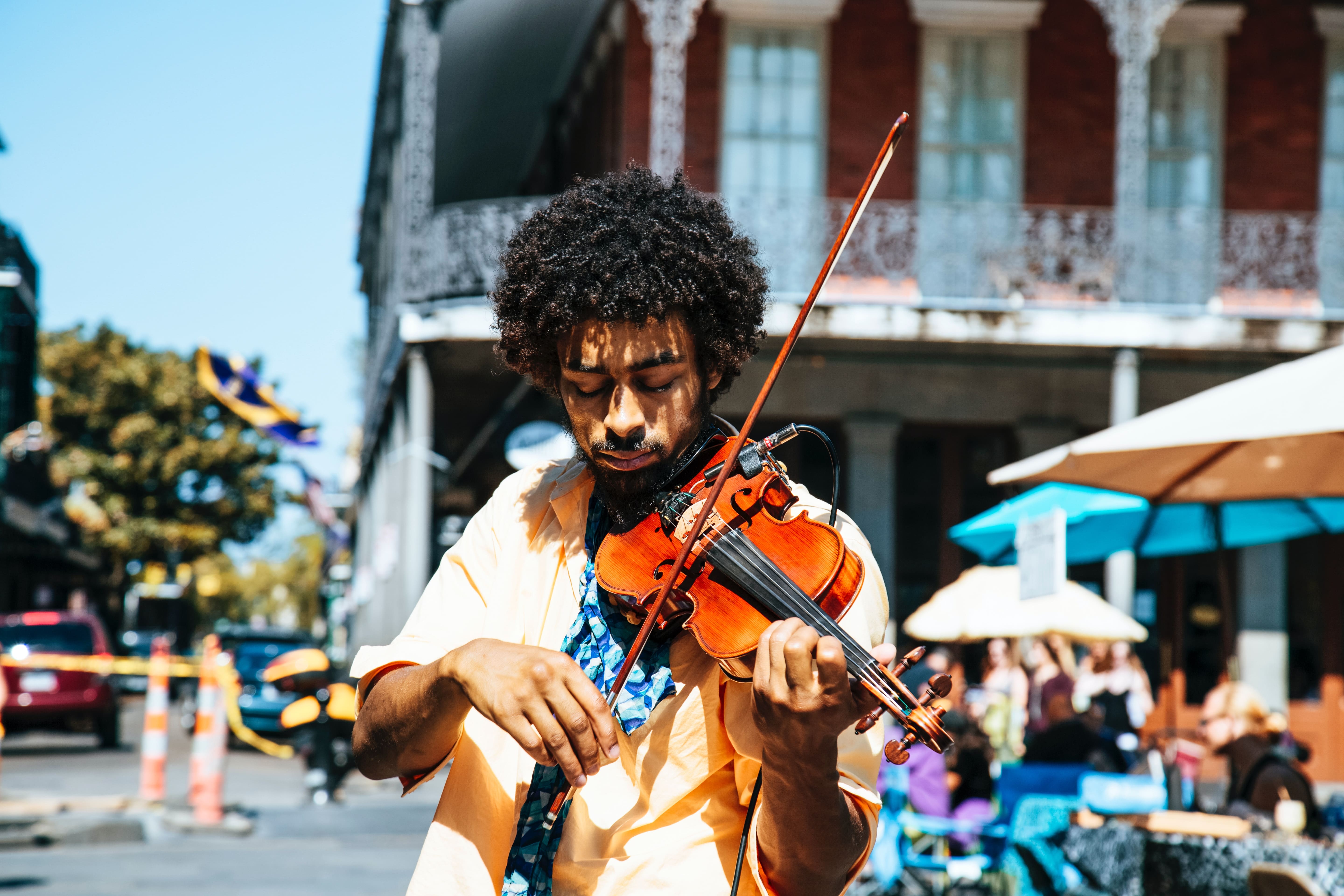 man playing the violin on the street
