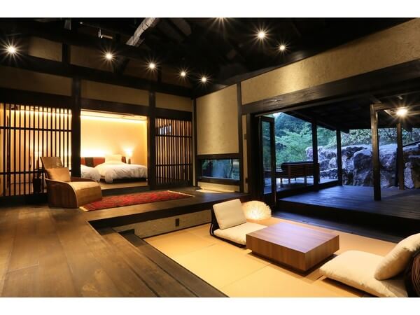 일본 전통 다다미 방과 서양식 침실이 결합된 오쿠노유의 객실 내부. 실내 테라스와 자연이 어우러진 조화로운 분위기