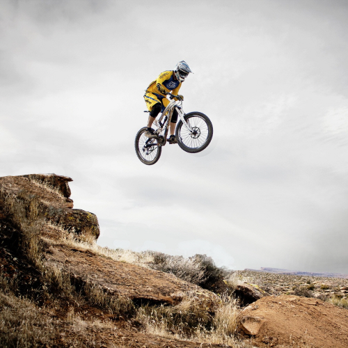 Determined cyclist climbing steep hill demonstrating mental strength and focus during uphill ride