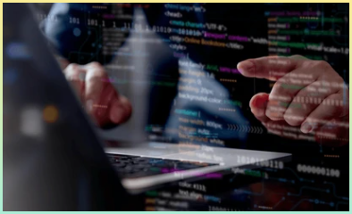 노트북으로 코딩을 하는 것을 표현한 사진. 코드들이 비치며 손으로 가리키고 있다.