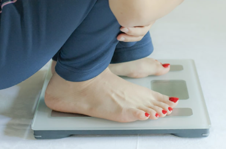 체중계를 타는 여자.