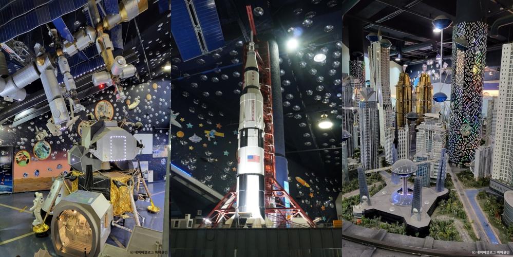 강화도 옥토끼 우주센터 실내 전시: 우주정거장, 로켓, 미래도시 모형이 전시된 모습