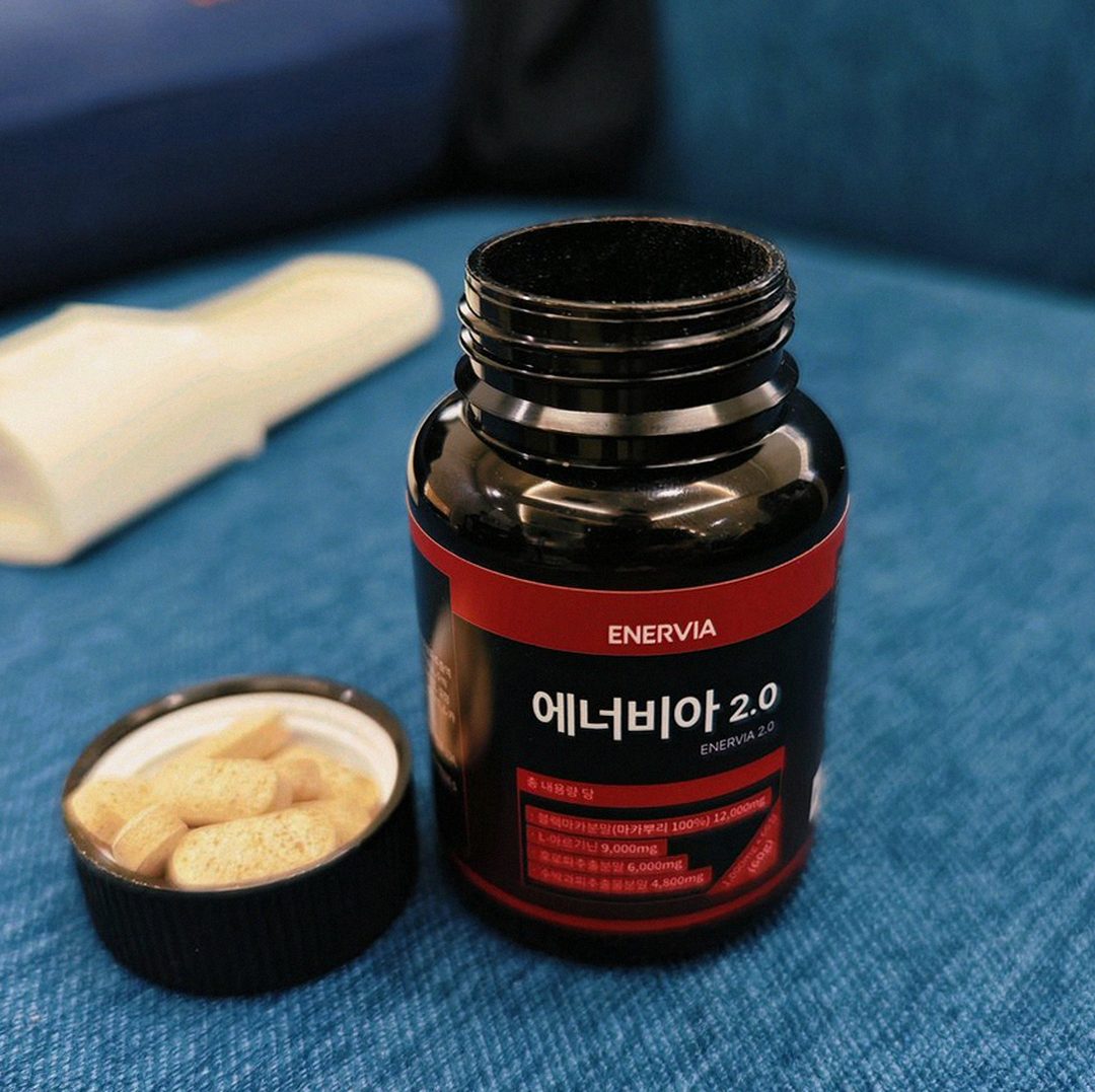 Korean Asian man 40s taking supplement during lunch break construction site