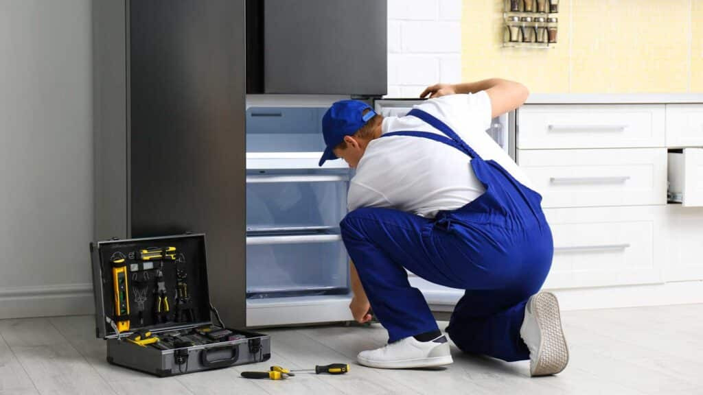 Refrigerator Self-Repair Guide - Man Working with Repair Tools