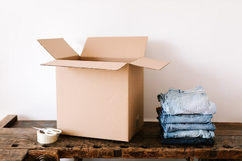 Box and folded jeans for donation