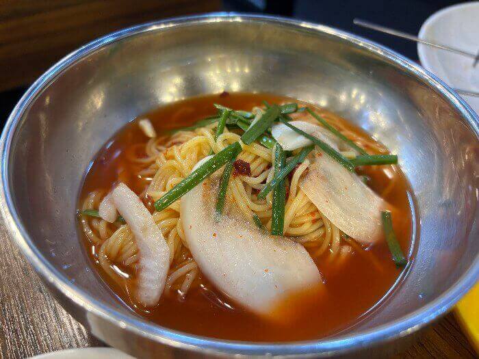 빨간 육수에 옥수수면이 담긴 그릇