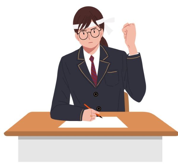 수험생이 책상 앞에서 두 주먹을 불끈 쥐고 화이팅을 외치는 장면