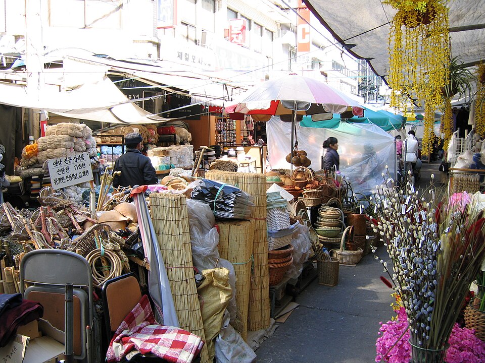 Shoppers pass stalls filled with woven baskets, straw mats, branches and household goods at Seomun Market in Daegu.