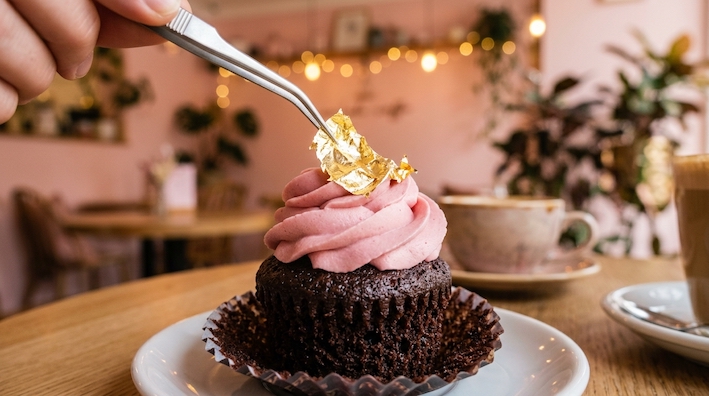 chocolate cupcake with pink cream + gold leaf
