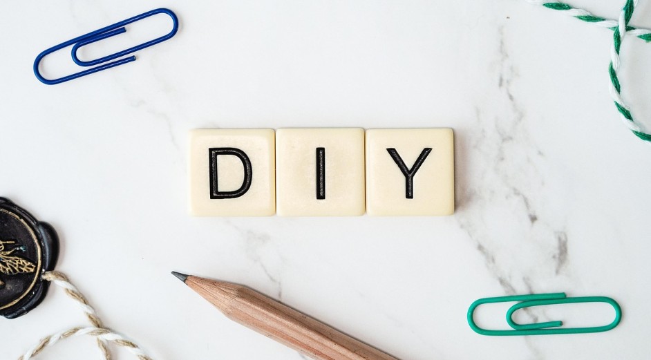 DIY letter sign with a pencil and paper clips