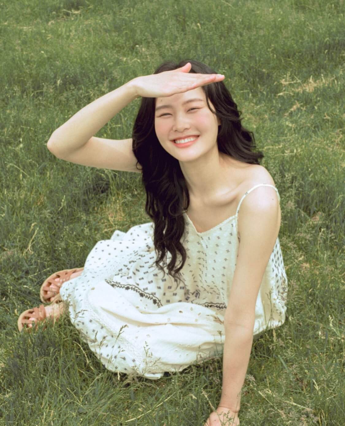 신지훈이 잔디밭에서 눈이 부신듯 이마에 손을 올리고 활짝 웃는 사진 