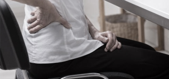 의자에-앉아-허리를-누르는-사람