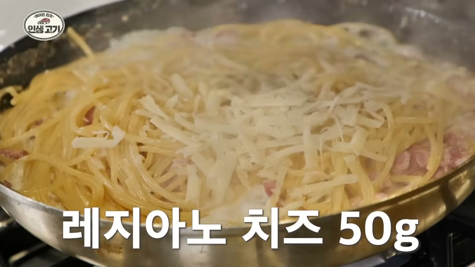 면 위에 레지아노 치즈를 뿌리는 장면