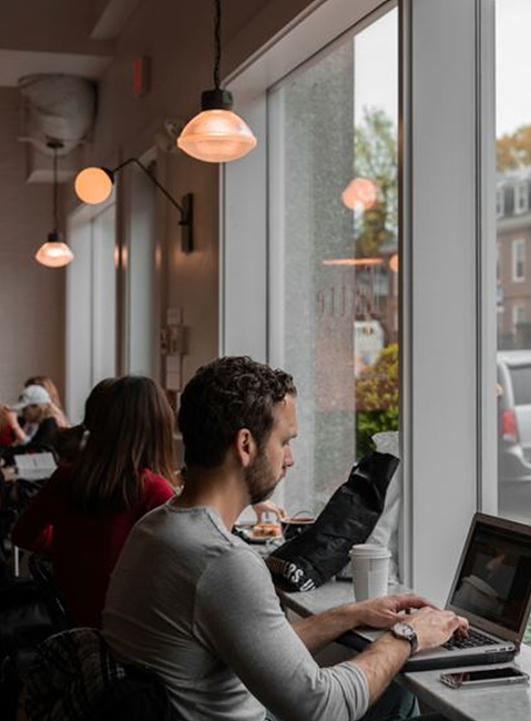 카페에서 노트북으로 일을 하는 사람들 사진