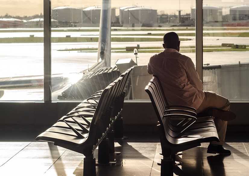 공항 안에 앉아서 기다리는 남성의 모습
