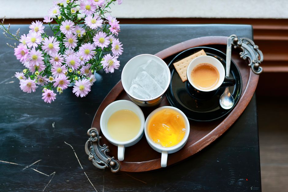 Charming coffee setup with floral arrangement, perfect for a warm and inviting atmosphere.