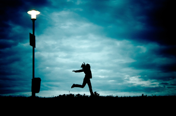어두운 저녁 한 여성이 자유롭게 뛰어가고 있는 모습