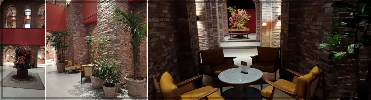 빌라쥬드-아난티-루-분위기-밝은색-벽돌로-벽을-데코하고-화분이-매우-커서-나무같은-느낌-테이블과-의자도-멋스러움-층고가-높음