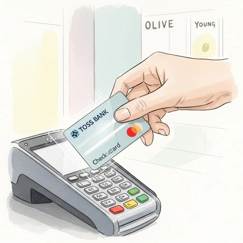 토스뱅크 체크카드로 결제하는 손의 클로즈업